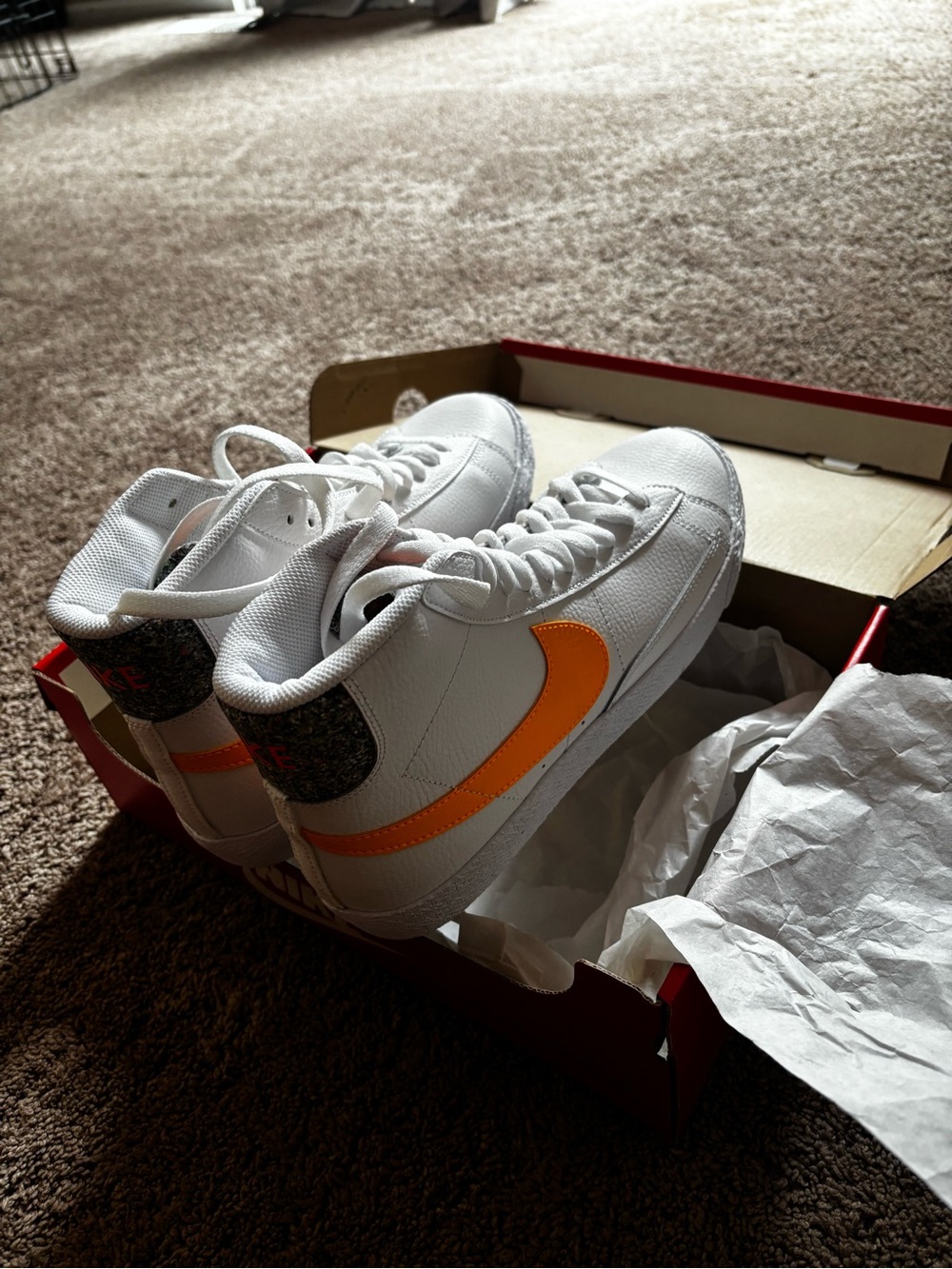 Nike White Mid-Top Sneakers with Orange Swoosh